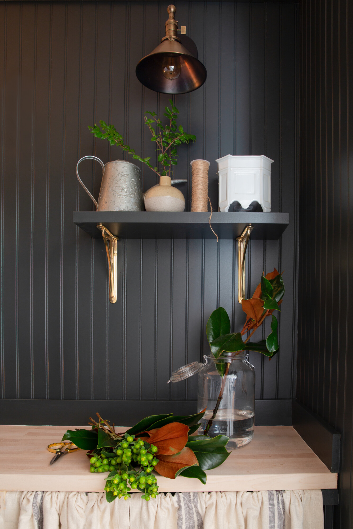 Open shelf with brass brackets and styling by Clouz Houz