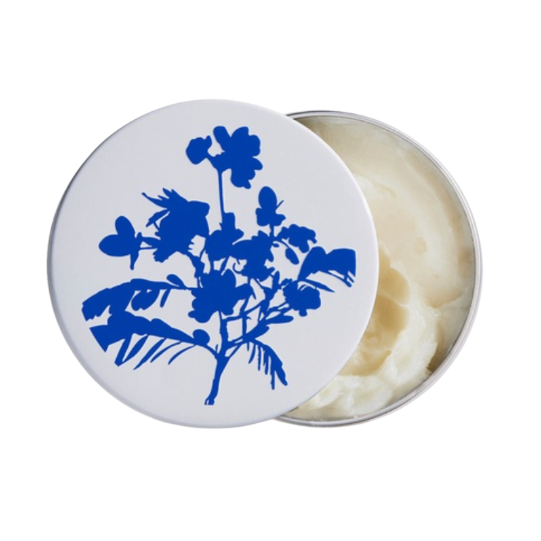 Luxurious skincare balm in a round tin with cobalt blue botanical illustration on the lid.
