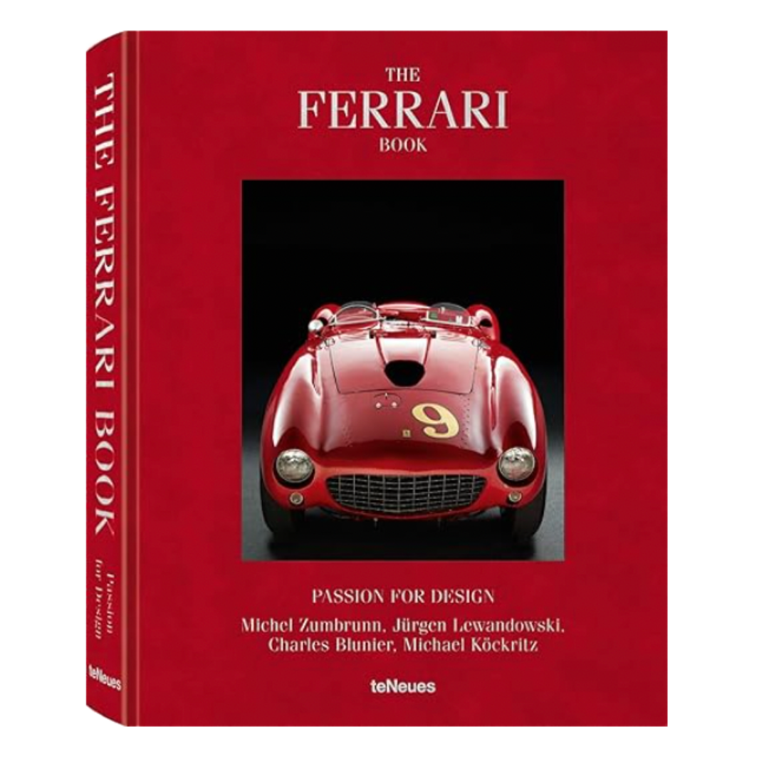 Red hardcover coffee table book titled “The Ferrari Book” featuring a vintage Ferrari on the cover.