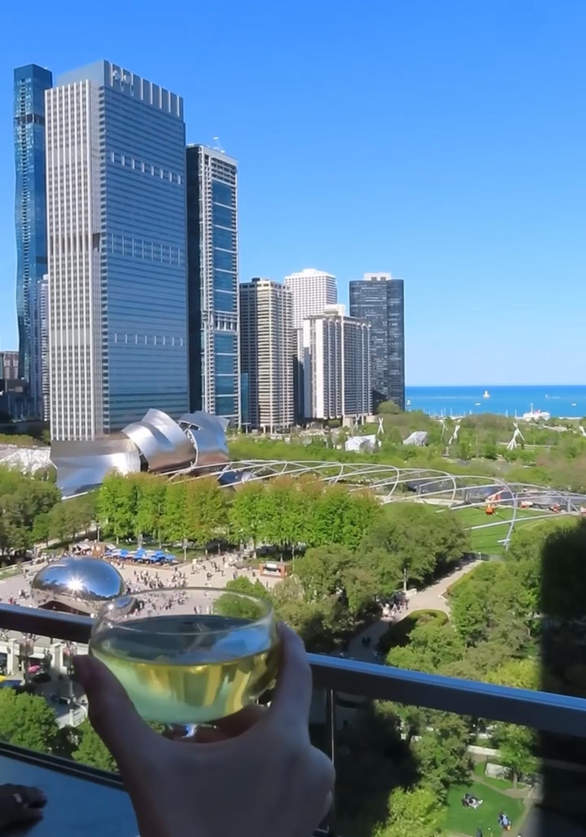 Chicago skyline shot from Cindy's Rooftop with a glass of champagne in hand