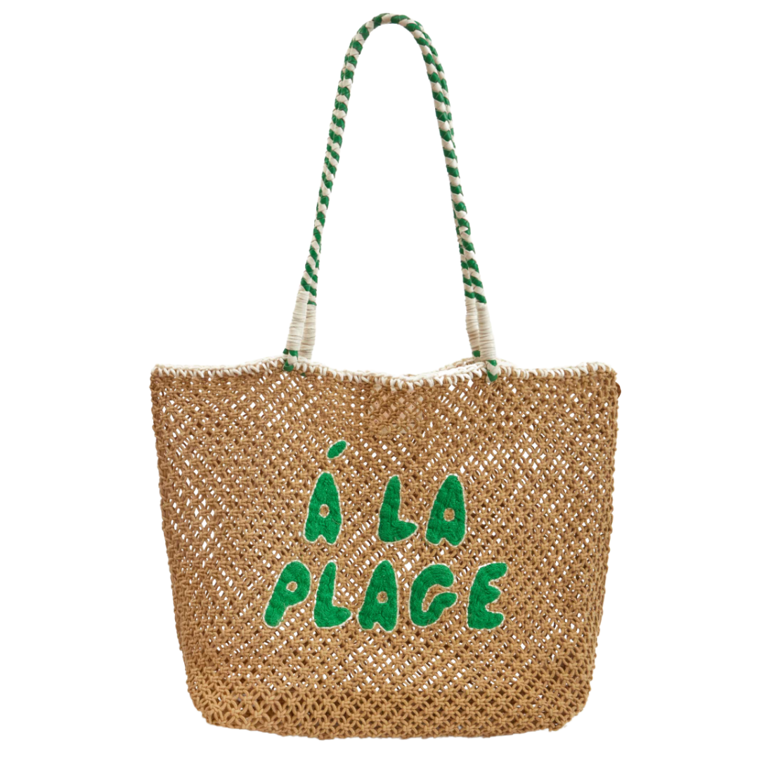 A beachy woven tote with green lettering and striped handles, casual and fun for summer outings.