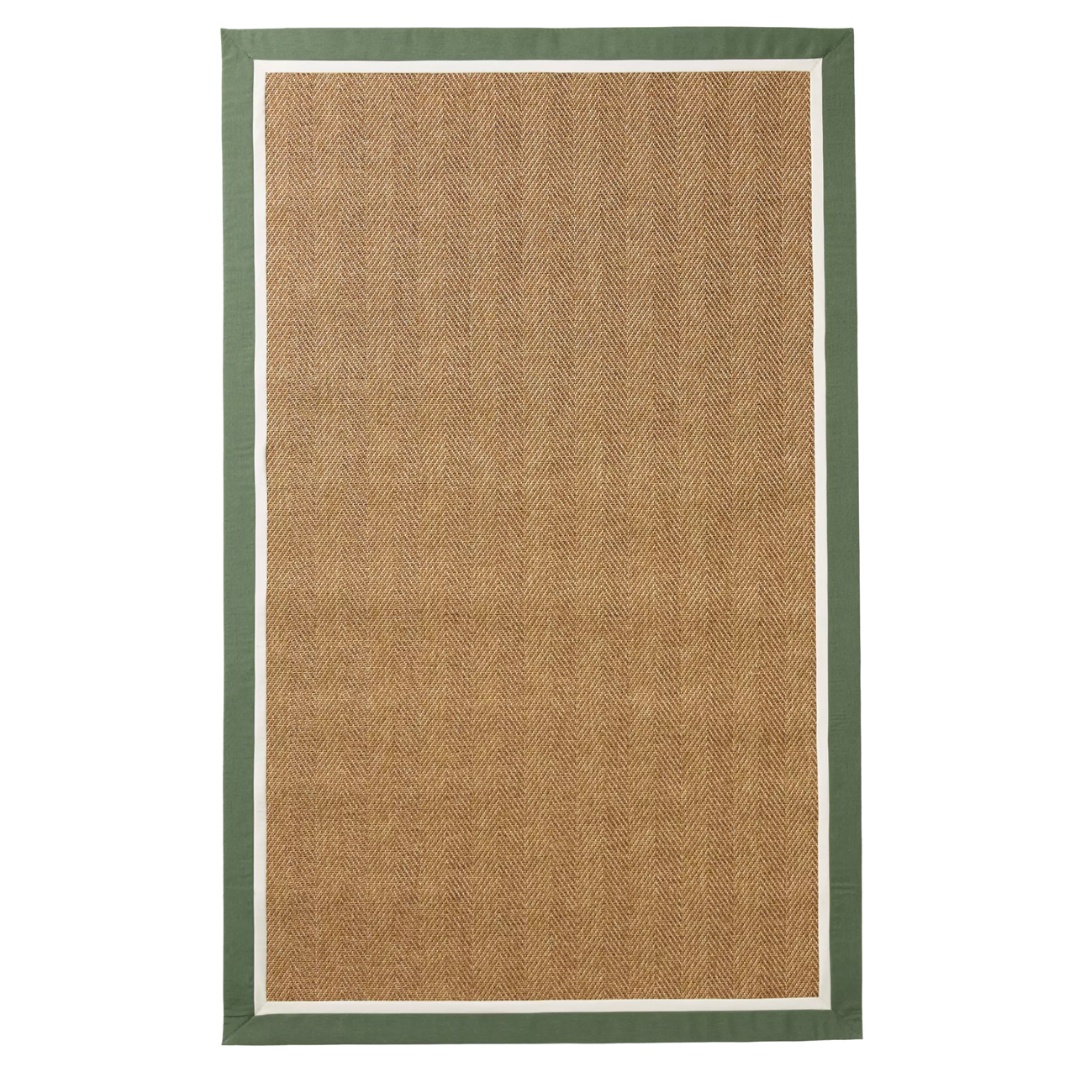 A tan herringbone-style outdoor rug with a green and ivory double border.