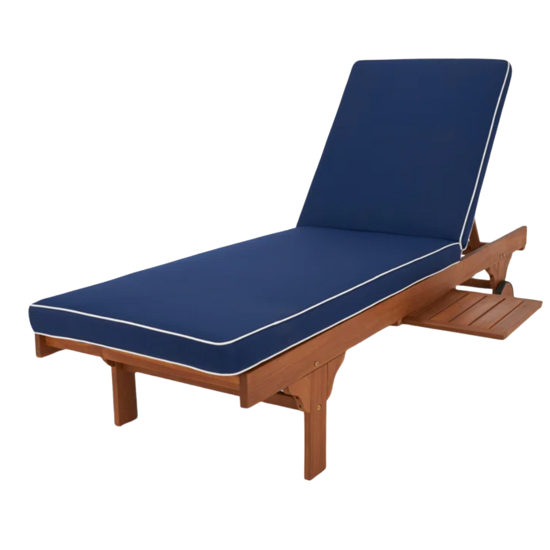 A wooden framed outdoor chaise with navy blue cushions trimmed in white piping and a pull-out tray.