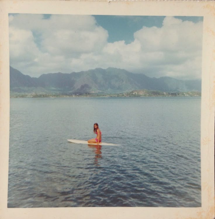 image of women on surf board. polaroid/film style.