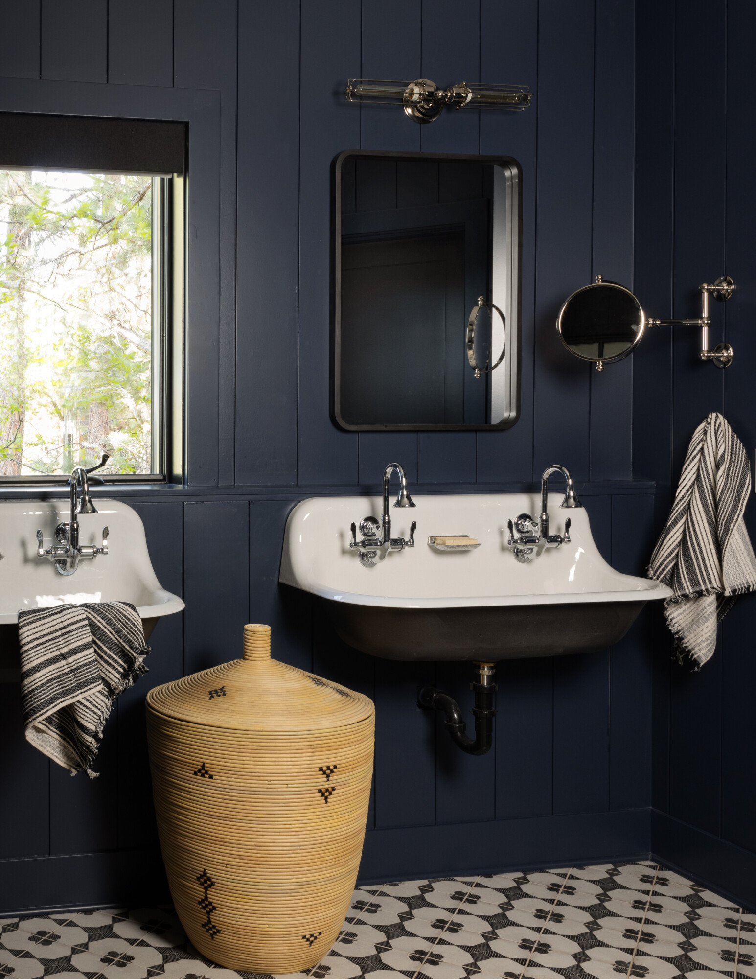 Bathroom with painted tongue and groove walls, showcasing a moody palette and vintage-inspired hardware.