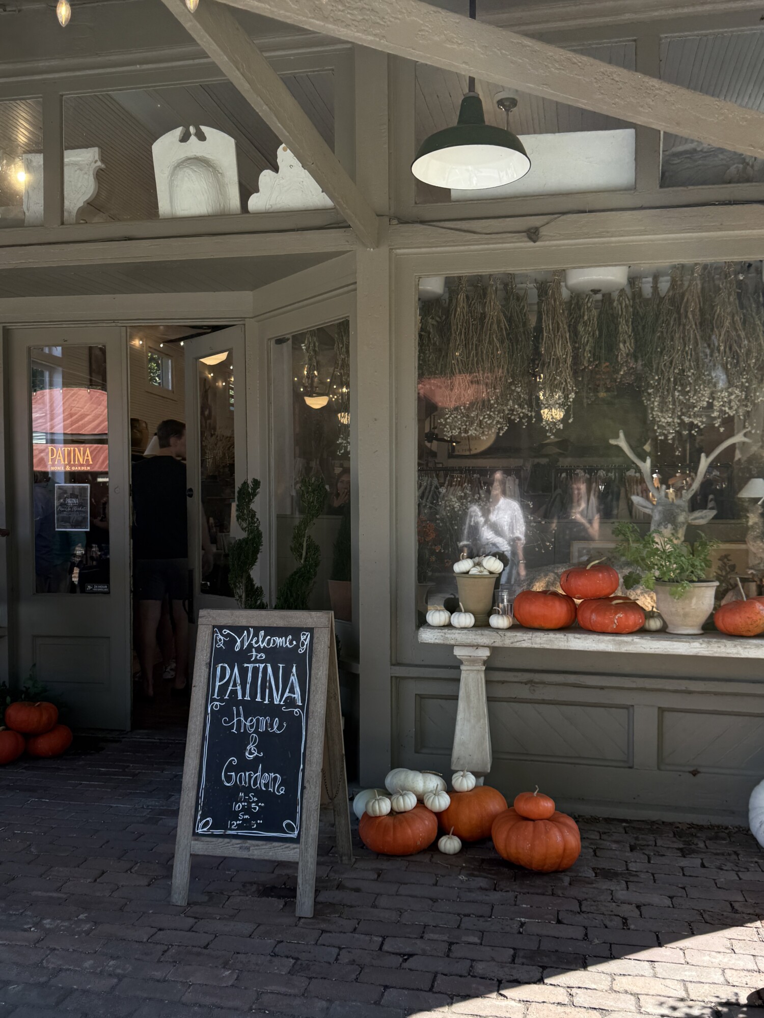 Patina Home & Garden storefront in Leiper’s Fork with pumpkins and chalkboard welcome sign.