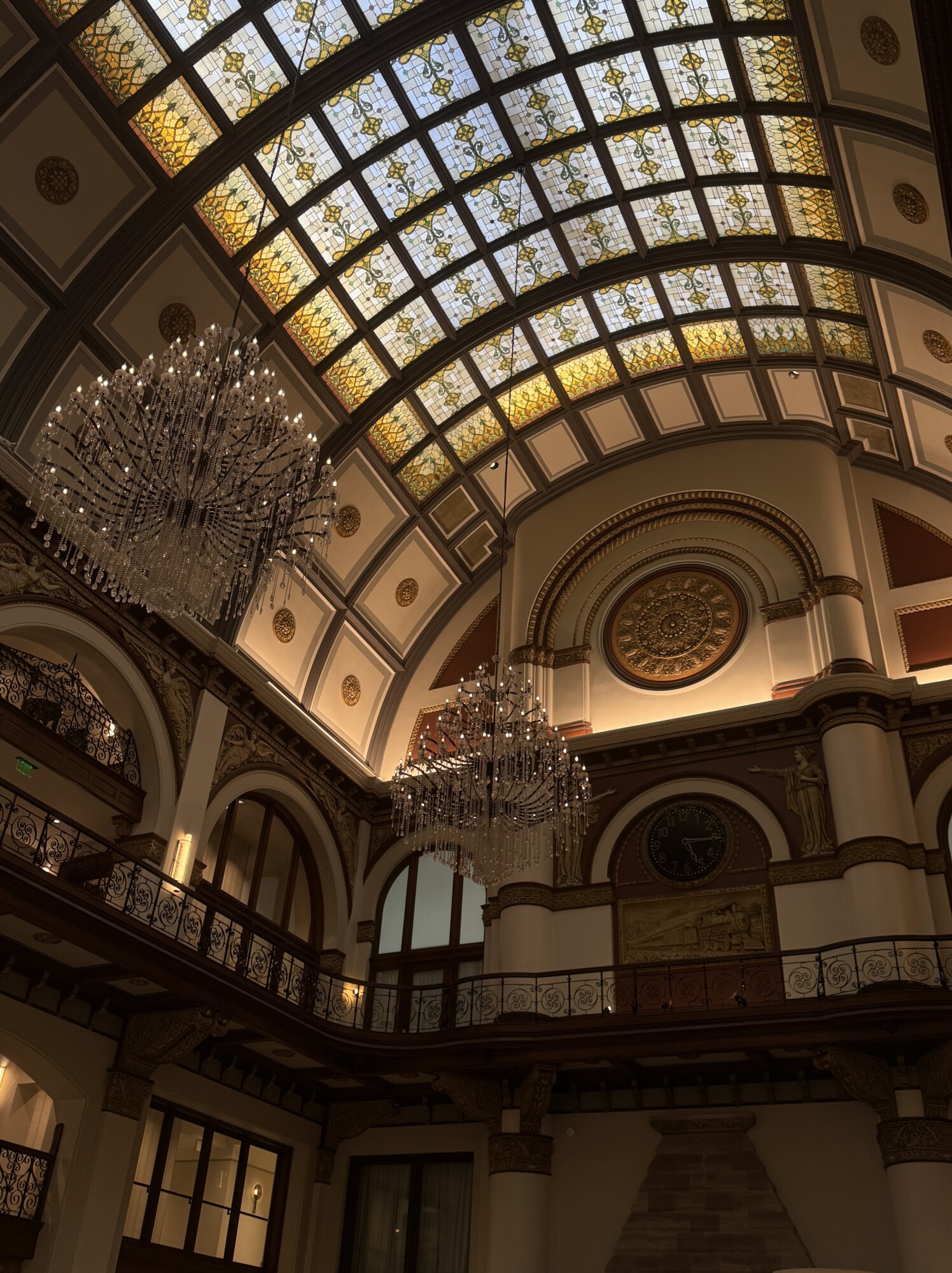 Union Station Hotel Nashville lobby with arched stained-glass ceiling and chandeliers.