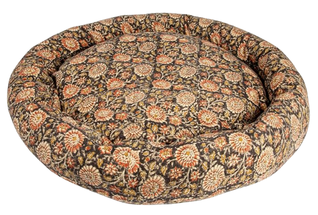 Round dog bed in vintage floral block print—rust and olive blooms on charcoal base.
