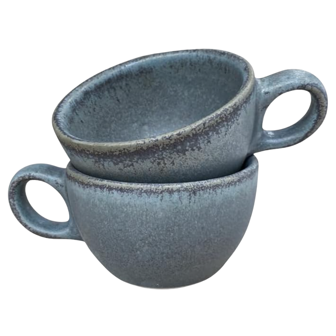 Stacked muted-blue stoneware mugs with rustic speckled glaze—organic, hand-thrown look.