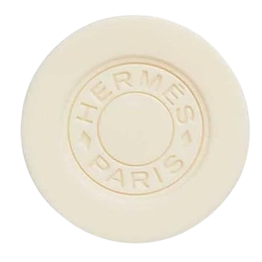 Ivory Hermès Paris round bar soap with embossed logo—luxury bath accessory.
