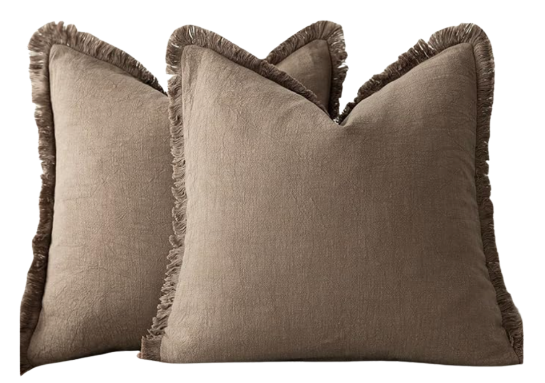 Pair of deep-taupe linen throw pillows with delicate fringe—22-inch covers for layered sofas or beds.