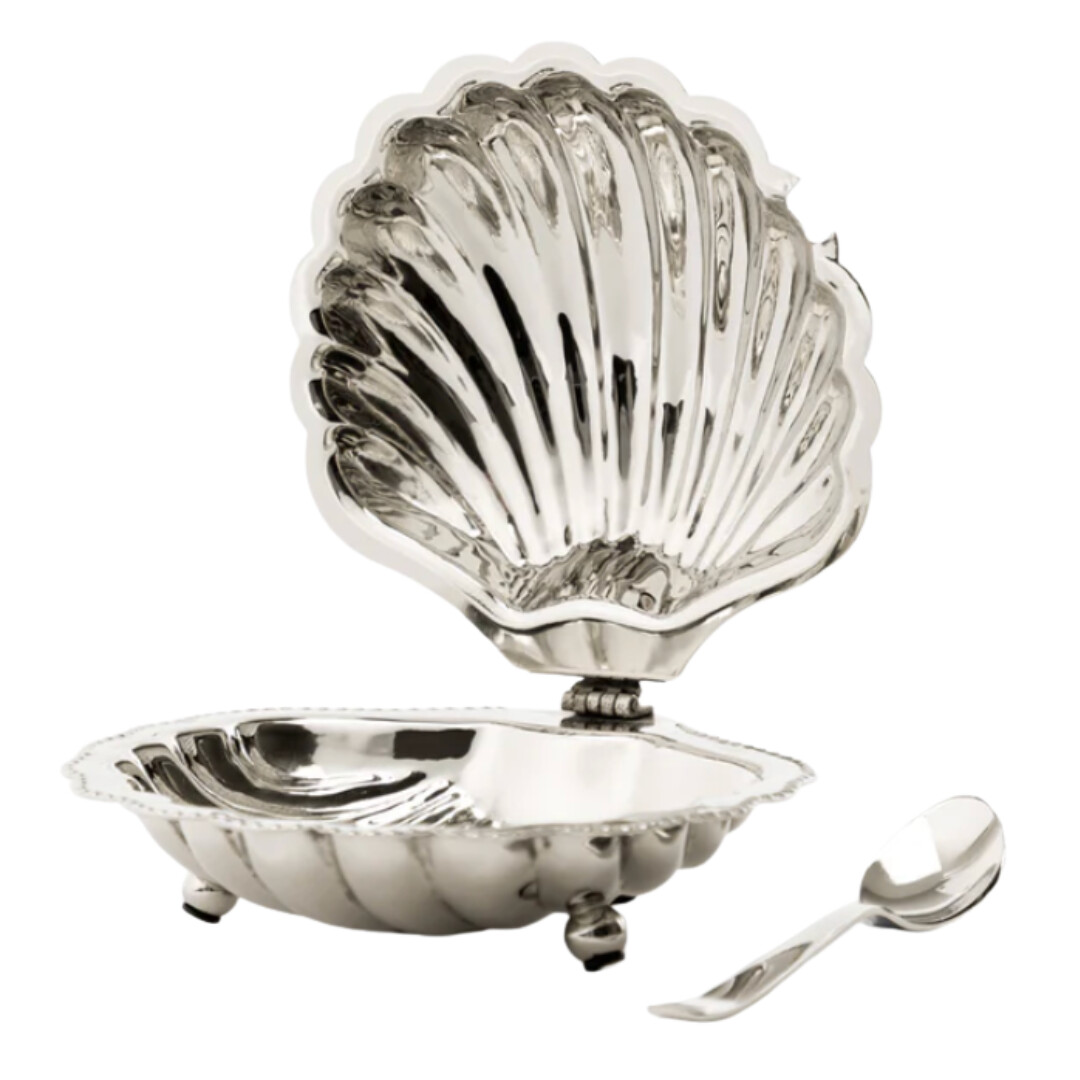 Silver shell dish with a matching spoon, designed for serving or tabletop display.