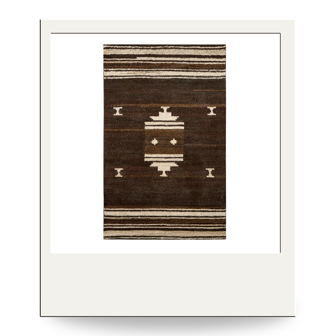 A brown and cream wool rug featuring a bold geometric Southwestern-inspired pattern for earthy warmth.