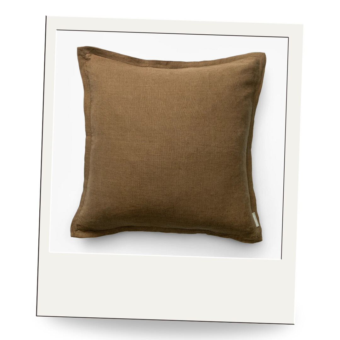 Soft brown linen pillow with natural texture and flange edge, ideal for layering on sofas, chairs, or beds.