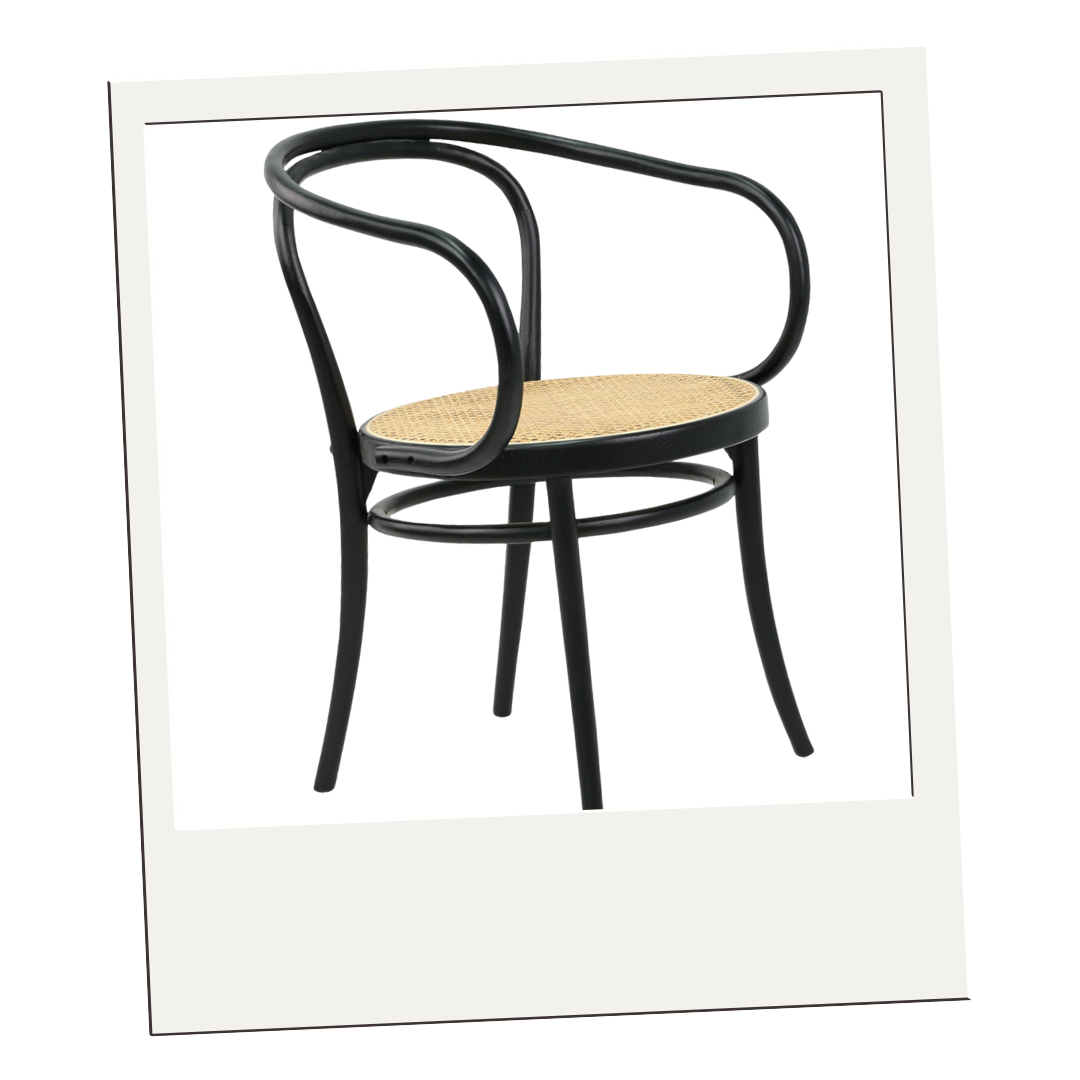 Classic bentwood bistro chair with black frame and woven cane seat, shown in a minimal cream frame.