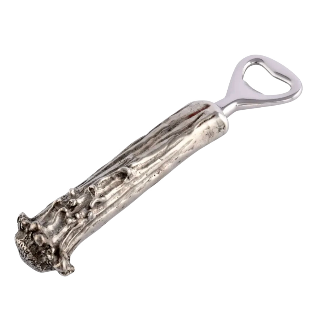 Silver bottle opener with a sculptural, branch-like handle and polished finish, blending rustic and refined design.