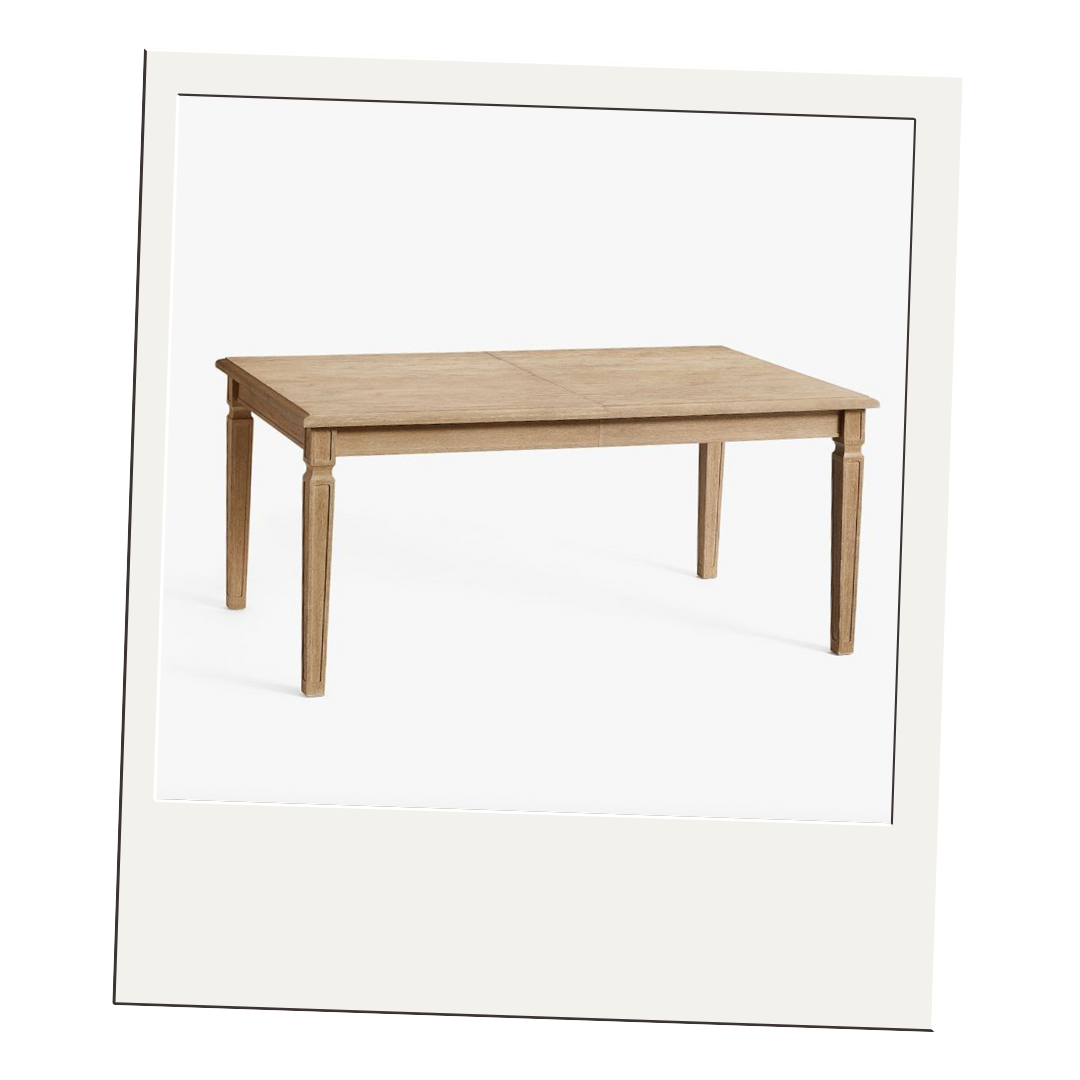 Light oak extendable dining table with tapered legs and classic proportions, styled in a minimalist white setting.