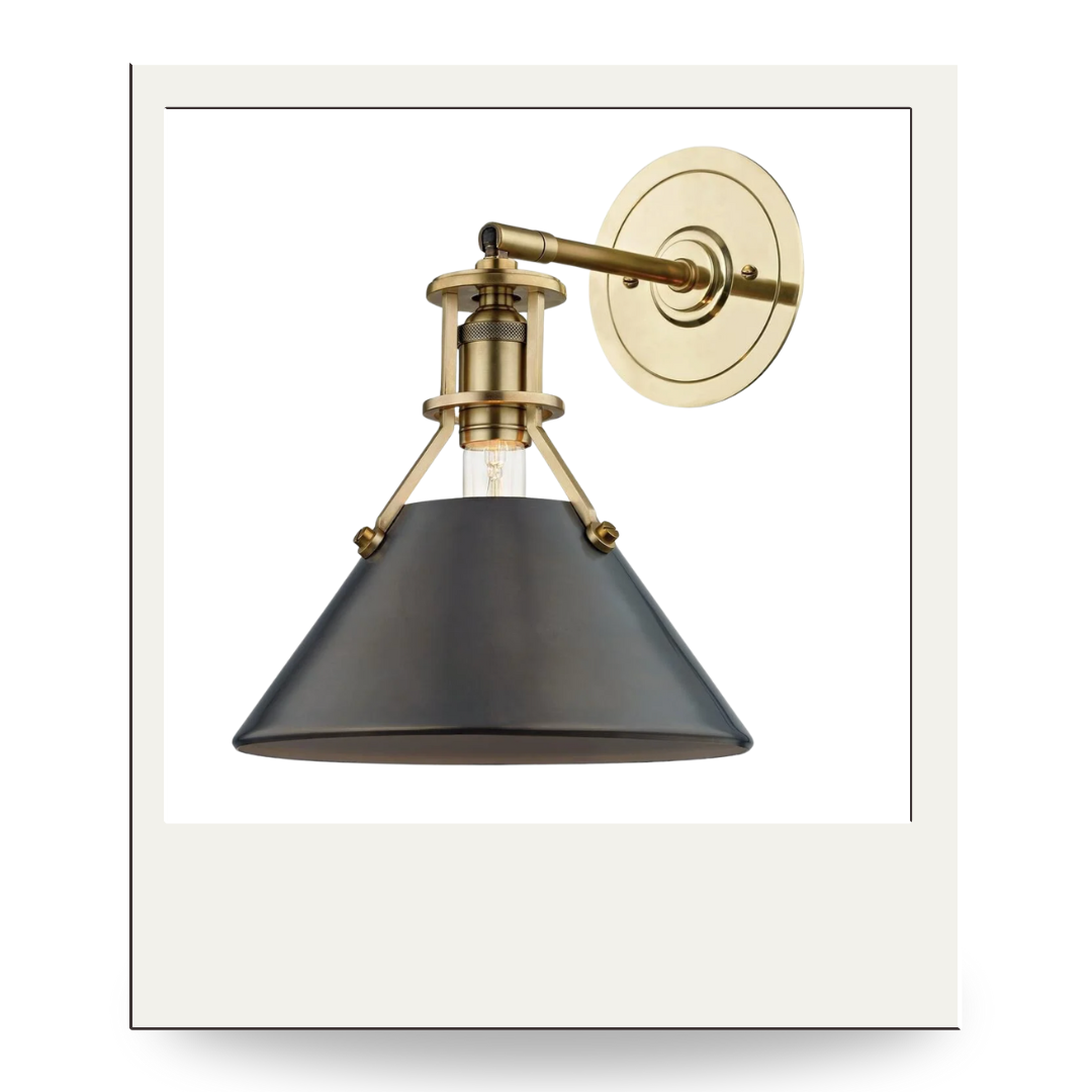 Brass and black sconce with a conical shade and adjustable arm, blending modern contrast with timeless design.