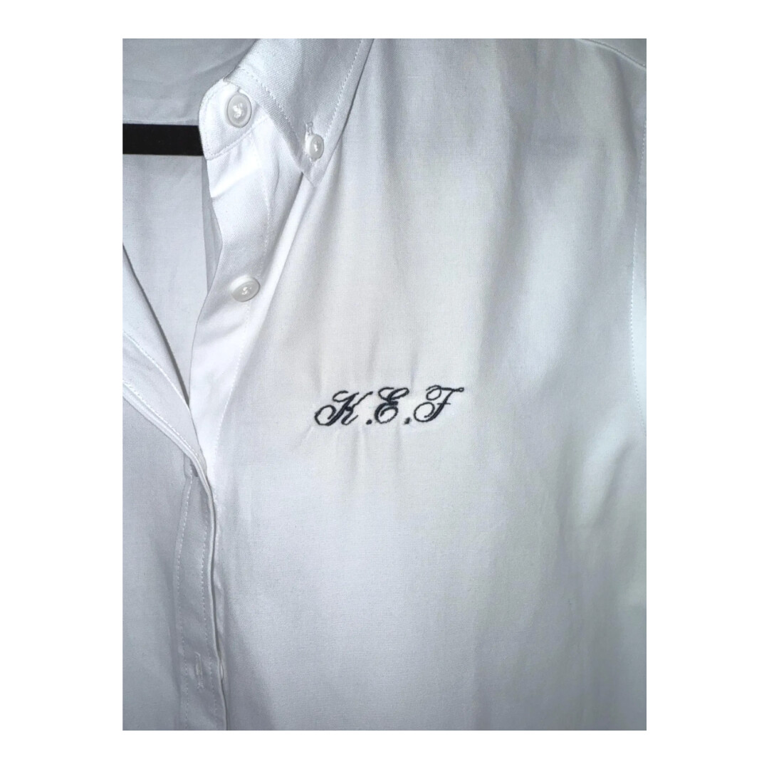 White cotton pajama shirt with custom black monogram embroidery, a timeless unisex gift that makes holiday mornings feel special.