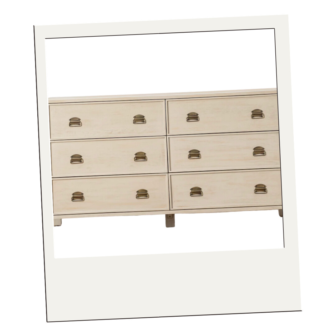 A six-drawer light wood dresser with brass cup pulls, combining timeless craftsmanship and modern simplicity.
