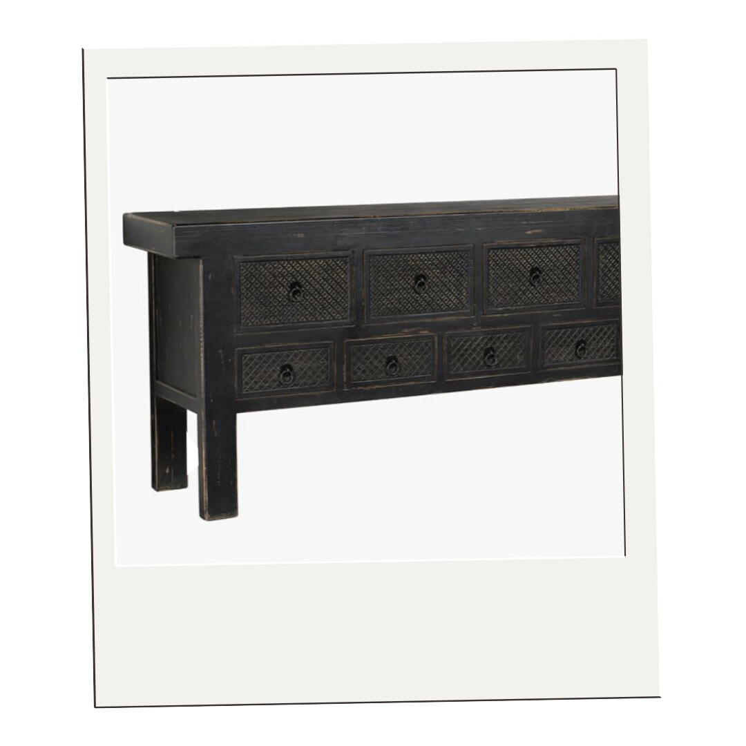 Distressed black console table with multiple drawers and textured detailing, ideal for entryways or behind a sofa.