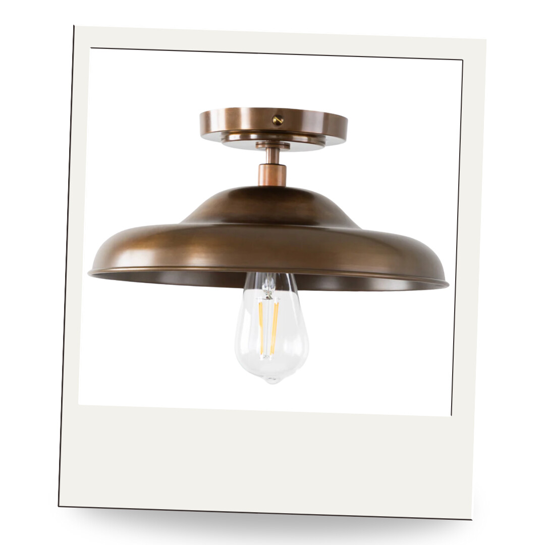 A round bronze semi-flush mount ceiling light with an exposed Edison bulb, offering industrial elegance.