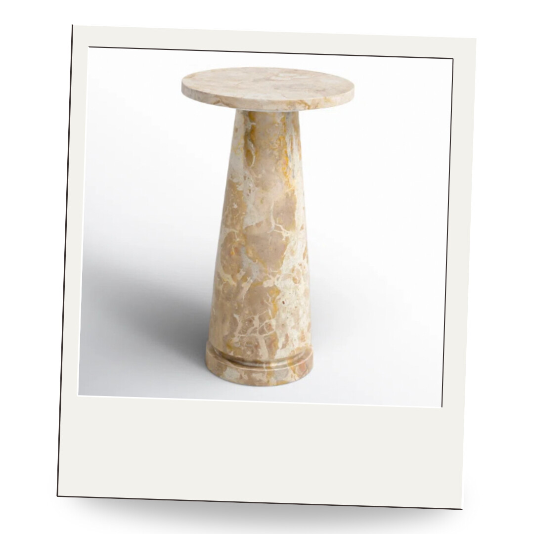 Sculptural marble drink table in warm beige tones, elegant next to an armchair or in a reading nook.
