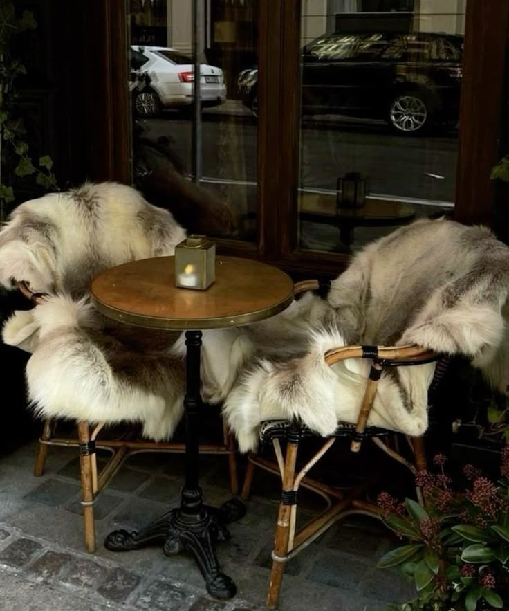 French bistrot table and chairs styled for the winter months with a fur throw