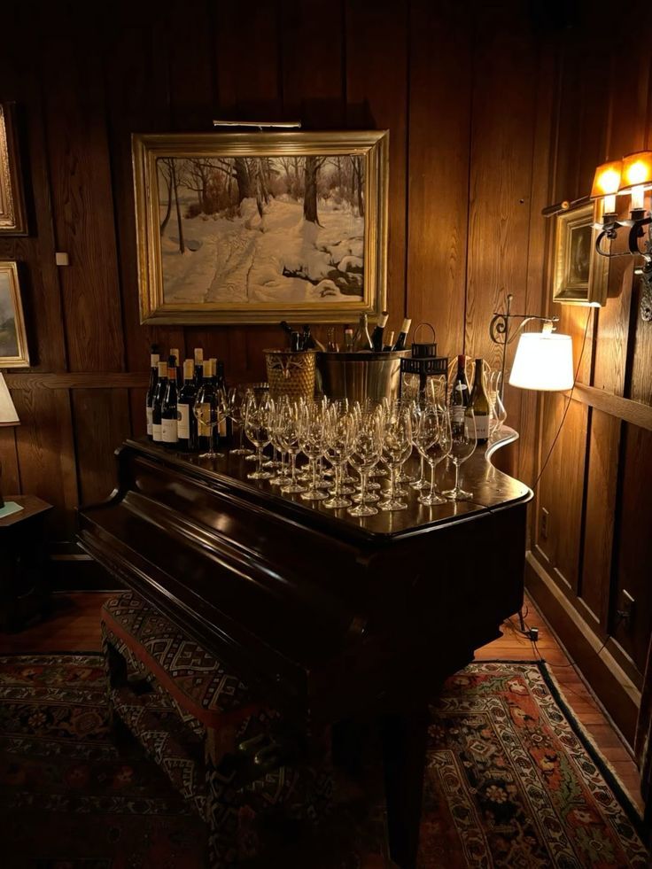 a piano styled with bar ware for a dinner party. hosting inspiration