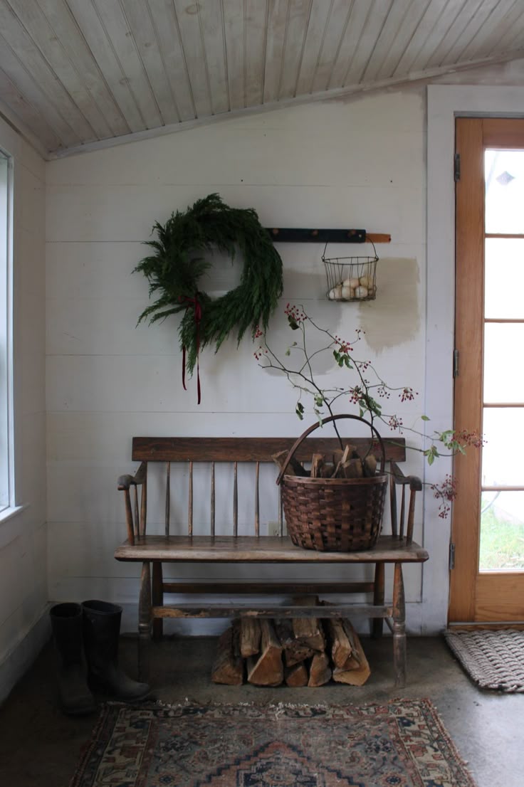 Entryway design with a simple rustic wooden bench and a understated wreath hanging above it.