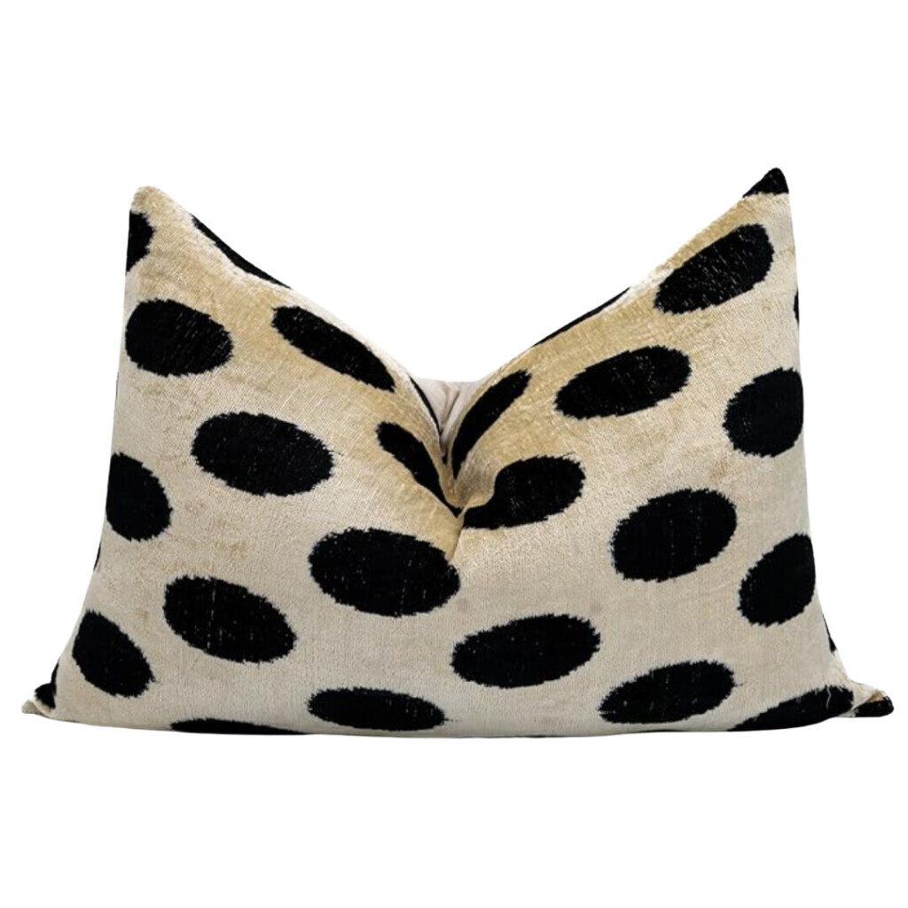 Beige velvet lumbar pillow with oversized black polka dot pattern