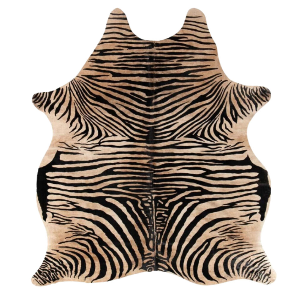 Zebra hide rug with bold black stripes on a warm tan background, organic edges, and natural pattern variation, used as a statement layering piece for a collected, old-world interior.
