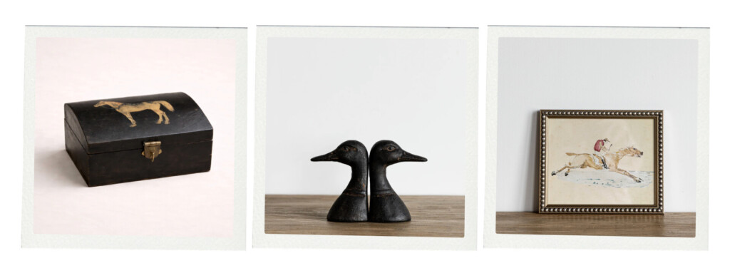 A collection of vintage-inspired decor including a small wooden box with a painted horse, two carved duck figurines, and a framed artwork of a rider on horseback.