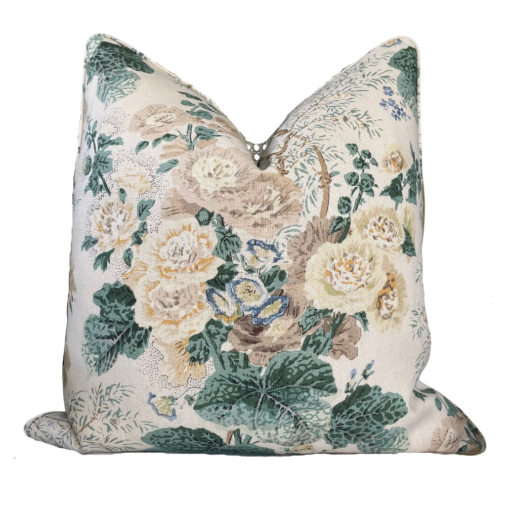 Floral patterned throw pillow in muted green, cream, and soft yellow tones